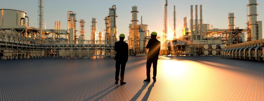 Two men looking at industrial plant