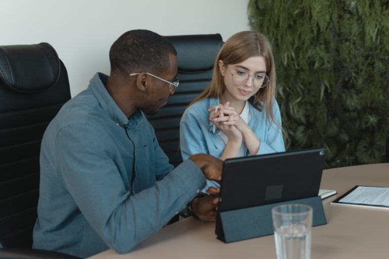 Man and woman looking at a computer